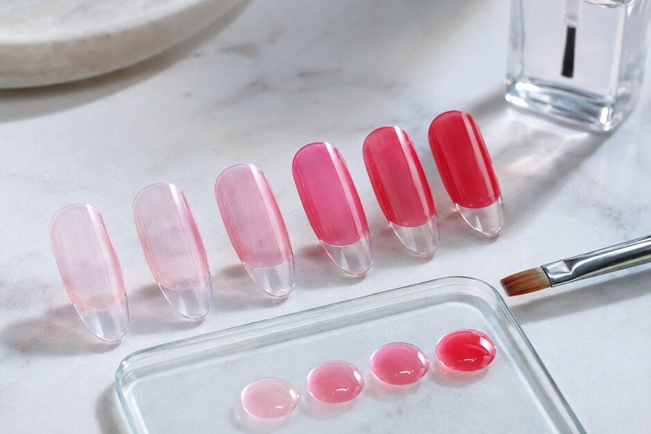 Six clear nail tips showing a clean progression from one sheer coat to luminous deeper color.